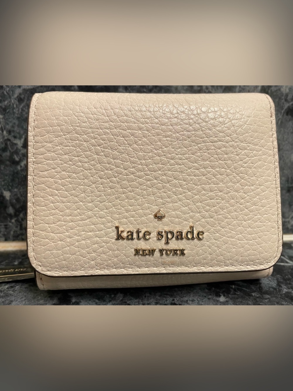 kate spade cream pebbled leather compact wallet with gold logo